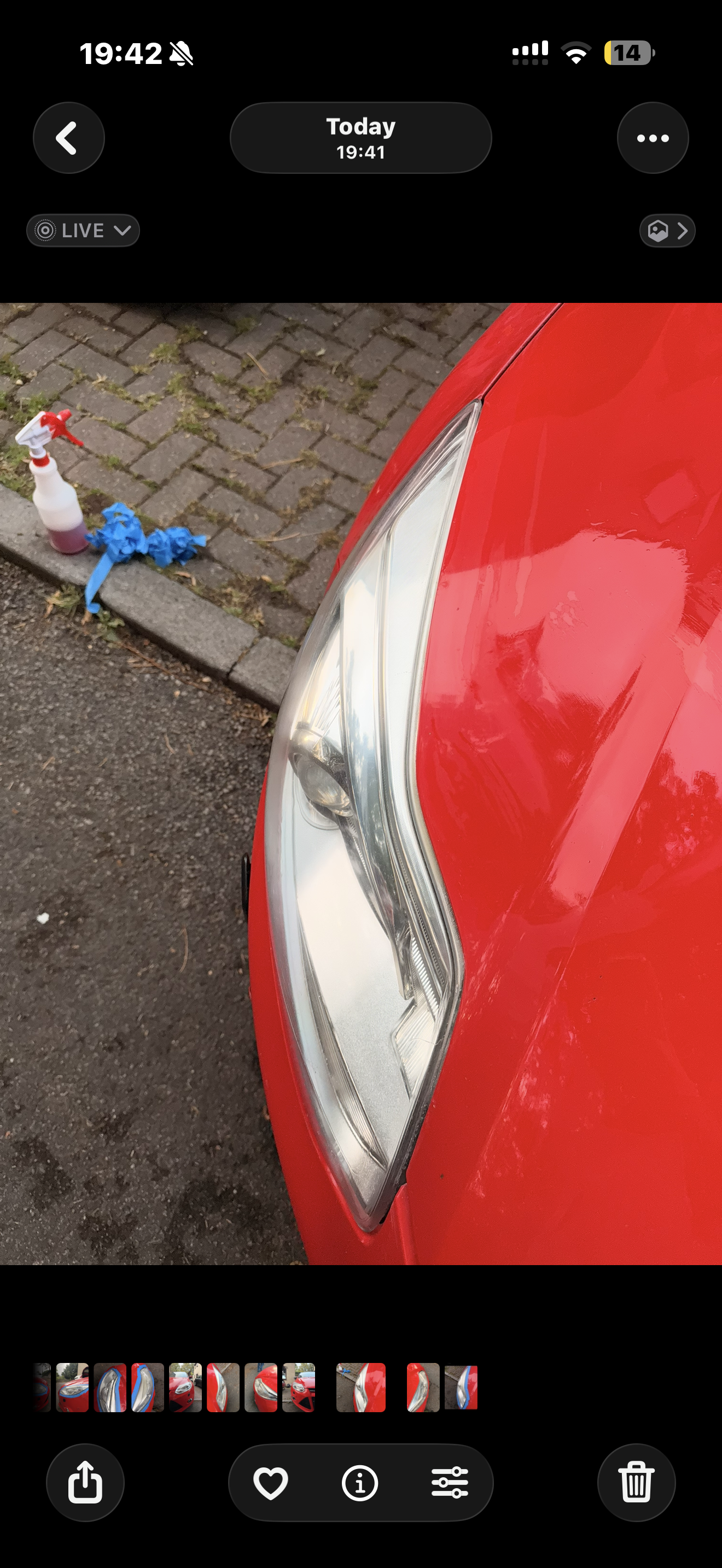 Red car headlight restored to a clear polished finish